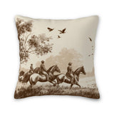 Decorative pillow with a vintage-style illustration of people on horseback and birds flying.