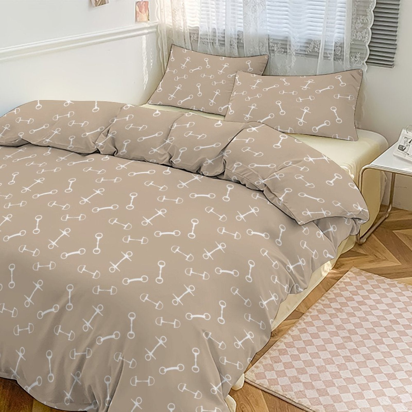 Beige and white patterned bedding set on a bed in a bedroom.