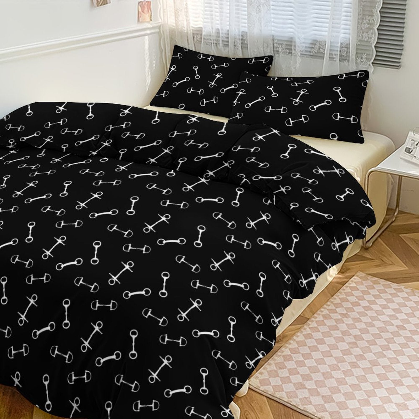 Black bedding set with white bone pattern on a bed in a bedroom.