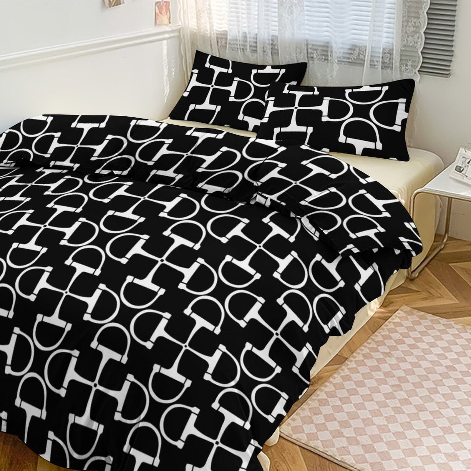 Black and white patterned bedding set on a bed in a bedroom.