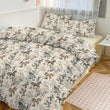 Bedding set with horse pattern on a bed in a bedroom.