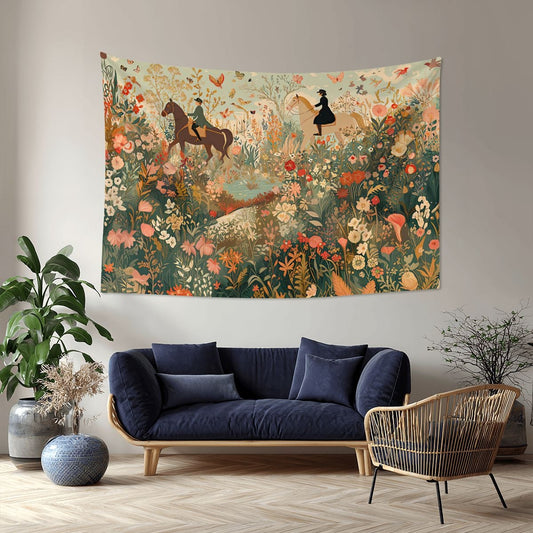 Decorative tapestry with a floral and horse design hanging above a blue sofa and wicker chair in a room.